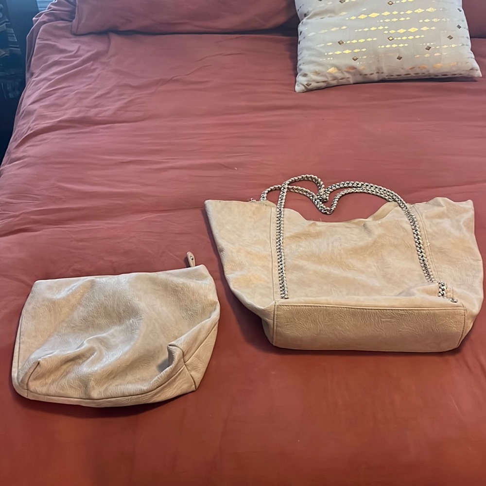 Cream colored purse with gold chain accent.